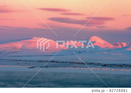 Winter aerial view of the coastline and mountains at sunset. 82726881