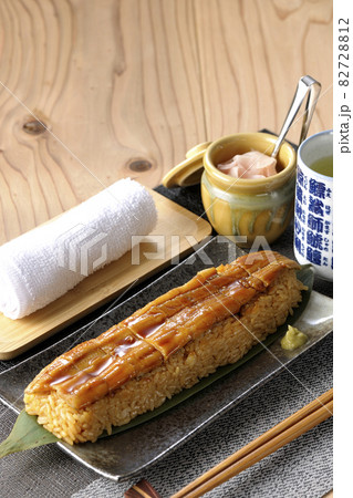 笹の葉に置かれた穴子の姿鮨と壺に入ったガリとお茶とお手拭き 笹の葉に置かれた穴子の姿鮨と壺に入ったガリとお茶とお手拭き 82728812