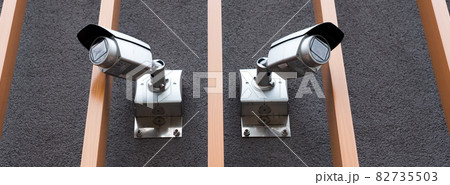 Security cameras on modern building. Professional surveillance camera. CCTV on the wall with LED IR lights. Security system, technology concept. Video equipment for safety system area control outdoor. Security cameras on modern building. Professional surveillance camera. CCTV on the wall with LED IR lights. Security system, technology concept. Video equipment for safety system area control outdoor. 82735503