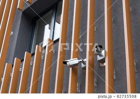 Security cameras on modern building. Professional surveillance camera. CCTV on the wall with LED IR lights. Security system, technology concept. Video equipment for safety system area control outdoor. Security cameras on modern building. Professional surveillance camera. CCTV on the wall with LED IR lights. Security system, technology concept. Video equipment for safety system area control outdoor. 82735508