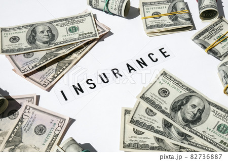 Text INSURANCE around US dollar banknotes. Health, life, home, car Insurance. Insurance business concept. Health care or medicare insurance and vaccination costs. Financial crisis. Covid-19 crimes Text INSURANCE around US dollar banknotes. Health, life, home, car Insurance. Insurance business concept. Health care or medicare insurance and vaccination costs. Financial crisis. Covid-19 crimes 82736887
