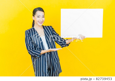 Portrait beautiful young asian woman with empty white billboard Portrait beautiful young asian woman with empty white billboard 82739453