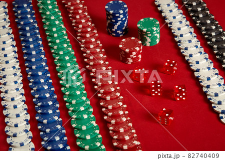 Stack of poker chips on red background at casino 82740409