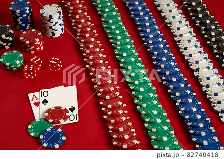 Poker cards and gambling chips on red background Poker cards and gambling chips on red background 82740418