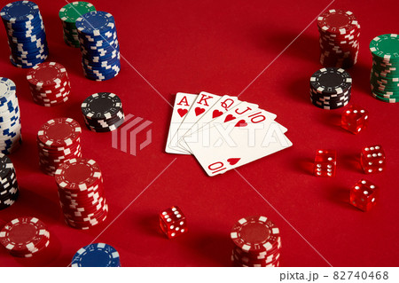 Poker cards and gambling chips on red background Poker cards and gambling chips on red background 82740468