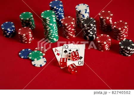 Poker cards and gambling chips on red background Poker cards and gambling chips on red background 82740502