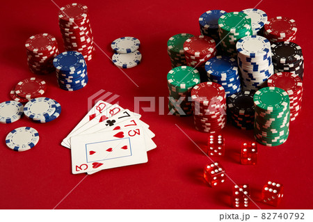 Casino gambling poker equipment and entertainment concept - close up of playing cards and chips at red background. Two pairs Casino gambling poker equipment and entertainment concept - close up of playing cards and chips at red background. Two pairs 82740792