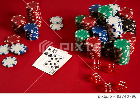 Two cards and chips on a red background. Big bet of game money. Cards - Ace and Ten. Your distribution at the table 82740796