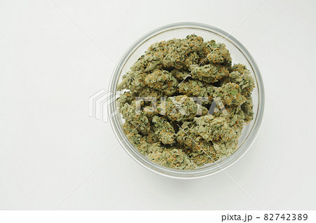 Marijuana buds in a jar. Medicinal cannabis stuff on white background, isolated, top view. 82742389