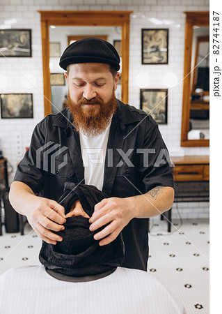 Professional barber, clipper preapring client for haircut, shaving at barbershop. Beauty, selfcare, style, fashion and male cosmetics concept. 82744187