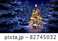 lightened christmas tree surrounded by snow-covered pine trees at night 82745032