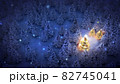 lightened christmas trees surrounded by snow-covered pine trees at night 82745041
