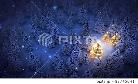 lightened christmas trees surrounded by snow-covered pine trees at night 82745041