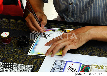 PUTRAJAYA, MALAYSIA -NOVEMBER 01, 2015: A man draw arabic calligraphy during Islamic Festival Event in Putrajaya, Malaysia. PUTRAJAYA, MALAYSIA -NOVEMBER 01, 2015: A man draw arabic calligraphy during Islamic Festival Event in Putrajaya, Malaysia. 82748145