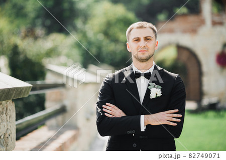 Headshot portrait of young man smiling isolated on outside outdoors background 82749071