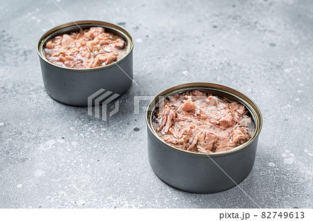 Open tin can with canned tuna fish. Gray background. top view Open tin can with canned tuna fish. Gray background. top view 82749613