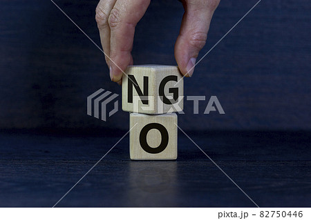 Hand flips a cube and changes the word NO to GO. Beautiful white background. Copy space. Business and motivational concept. Hand flips a cube and changes the word NO to GO. Beautiful white background. Copy space. Business and motivational concept. 82750446