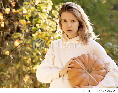 Cute Girl Choosing A Pumpkin One Fall Day. Young Cute Girl Choosing A Pumpkin One Fall Day. Young 82750672