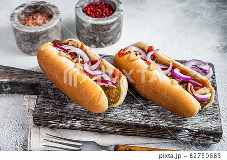 Vegetarian hot dog with with toppings and meatless sausage. White background. Top view Vegetarian hot dog with with toppings and meatless sausage. White background. Top view 82750685