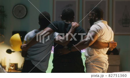 Black fans celebrating goal with toast Black fans celebrating goal with toast 82751360
