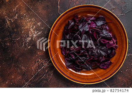 Raw Ruby or red chard salad Leafs on a rustic plate. Dark background. Top view. Copy space Raw Ruby or red chard salad Leafs on a rustic plate. Dark background. Top view. Copy space 82754174