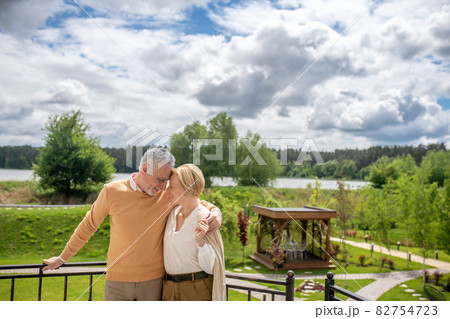 Romantic couple leaning their heads against each other Romantic couple leaning their heads against each other 82754723