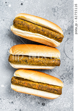 Vegan hot dog with meatless Vegetarian sausage. Gray background. Top view Vegan hot dog with meatless Vegetarian sausage. Gray background. Top view 82755116