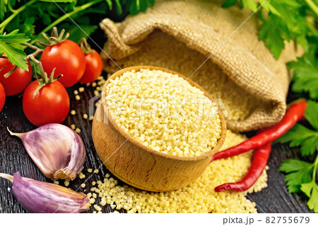 Couscous raw in bowl on wooden board Couscous raw in bowl on wooden board 82755679