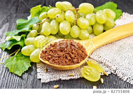 Flour grape seed in spoon on dark board Flour grape seed in spoon on dark board 82755806