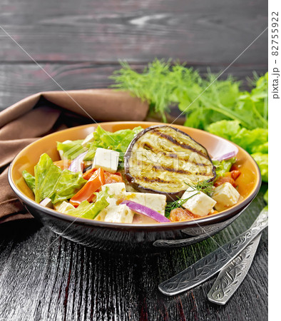Salad of eggplant with feta and tomatoes on wooden board Salad of eggplant with feta and tomatoes on wooden board 82755922