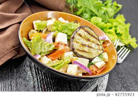 Salad of eggplant with feta and tomatoes on table Salad of eggplant with feta and tomatoes on table 82755923