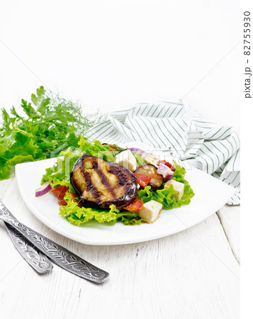 Salad of eggplant with cheese and tomatoes on table 82755930
