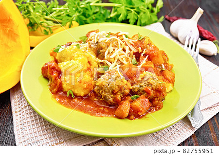 Porridge corn with meat and vegetables in plate on dark board Porridge corn with meat and vegetables in plate on dark board 82755951