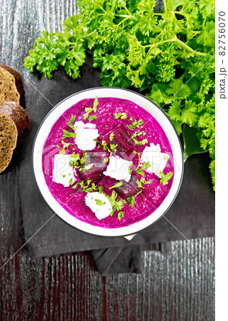 Soup puree of beetroot with salted cheese in bowl on dark board top Soup puree of beetroot with salted cheese in bowl on dark board top 82756070