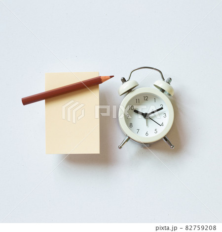 Blank memo paper, pencil, clock on white background. top view, copy space Blank memo paper, pencil, clock on white background. top view, copy space 82759208