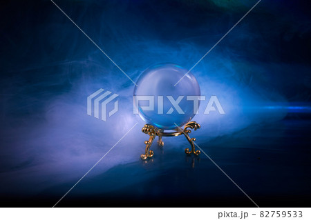 Crystal ball in a dark blue smoky background. Guessing for the future. Crystal ball in a dark blue smoky background. Guessing for the future. 82759533
