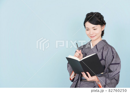 ノートを持つ着物の女性 82760250