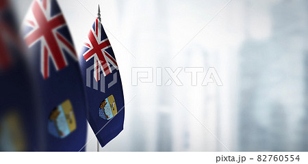 Small flags of Saint Helena on a blurry background of the city Small flags of Saint Helena on a blurry background of the city 82760554