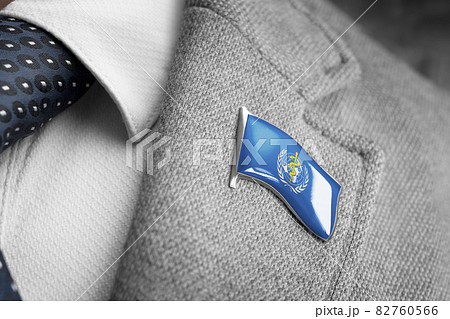 Metal badge with the flag of World Health Organization WHO on a suit lapel 82760566