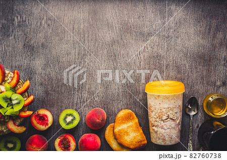 Ingredients for oatmeal on dark wooden table. Concept of healthy food. Top view, copy space. Toned 82760738