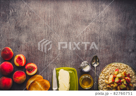 Ingredients for oatmeal on dark wooden table. Concept of healthy food. Top view, copy space. Toned 82760751
