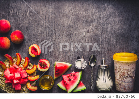 Ingredients for oatmeal on dark wooden table. Concept of healthy food. Top view, copy space. Toned Ingredients for oatmeal on dark wooden table. Concept of healthy food. Top view, copy space. Toned 82760760