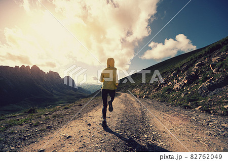 Woman trail runner running on mountain top 82762049