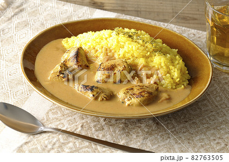 ランチョンマットに置かれたお肉ゴロゴロタンドリーチキンバターカレーとお茶 ランチョンマットに置かれたお肉ゴロゴロタンドリーチキンバターカレーとお茶 82763505