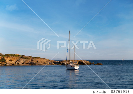 Sail Yacht cruising on deep blue sea water over blue sky Sail Yacht cruising on deep blue sea water over blue sky 82765913