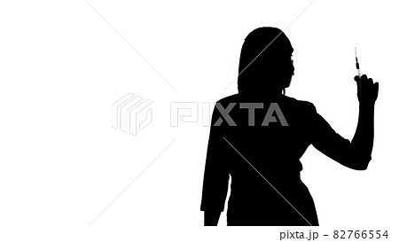 Photo of the woman's silhouette with syringe 82766554