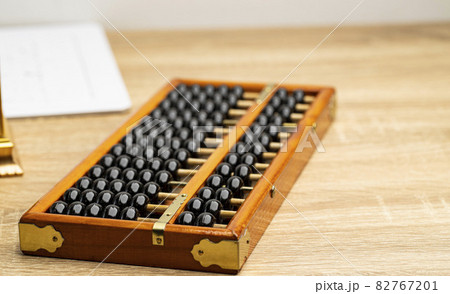 Chinese abacus vintage on the brown wood table front view and copy space 82767201