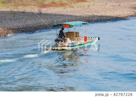 Man sails on the bamboo raft. Li River. Man sails on the bamboo raft. Li River. 82767226