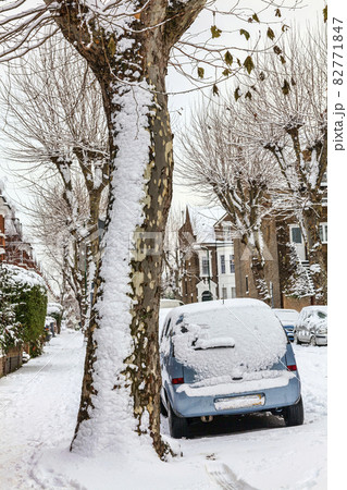 street winter cityscape with snow terraced houses and frozen cars 82771847