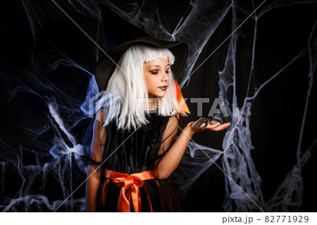 Little girl in witch Halloween costume having fun . Little witch 82771929